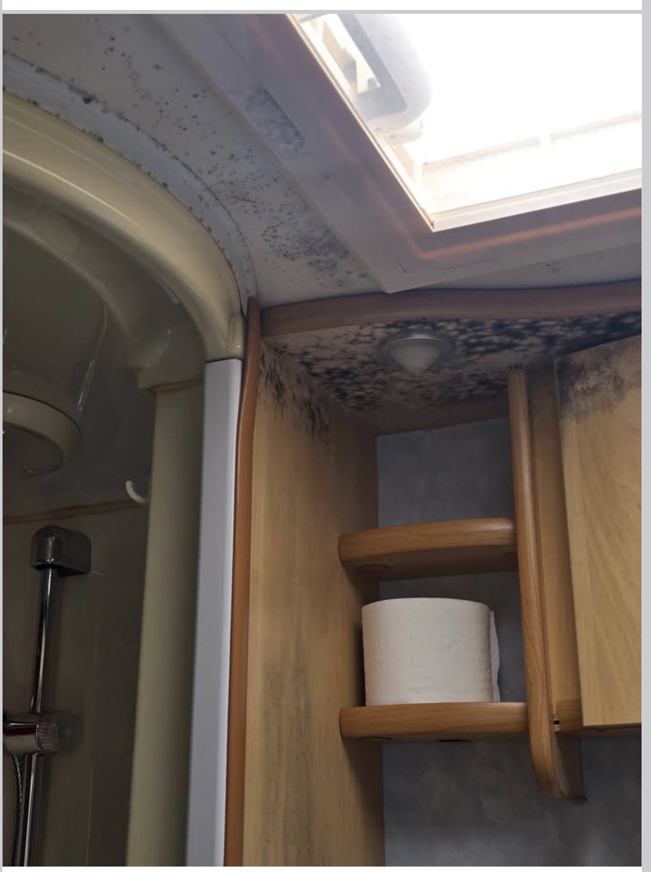 Dark mould-like growth in caravan overhead cupboard